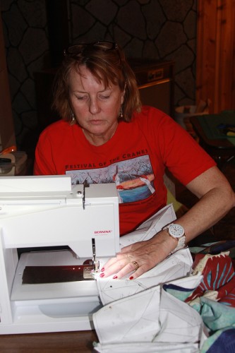Mary Chappelle sews on the third border.