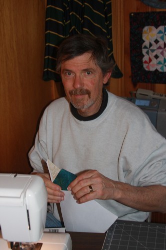 Steve Elkins uses paper foundation piecing techniques to stitch blocks for the quilt.