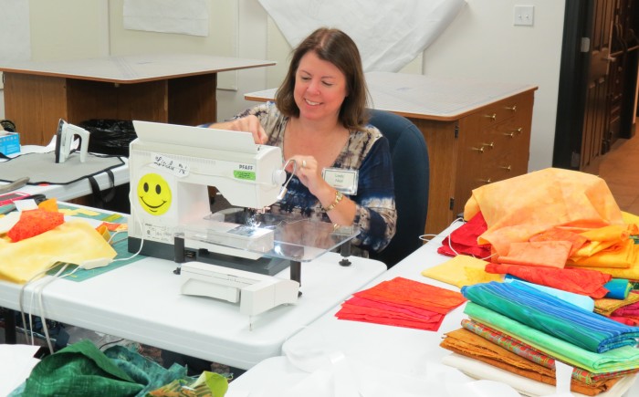 Linda Neal at her sewing area in the classroom at The Main House